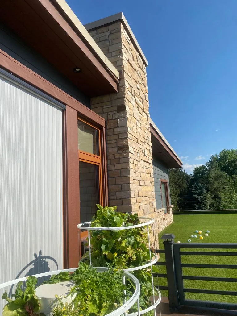 Stacked-stone veneer exterior with wood soffit, fascia and seamless gutters